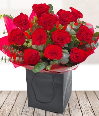 Luxurious Deep Red Roses in a beautiful hand tied Bouquet